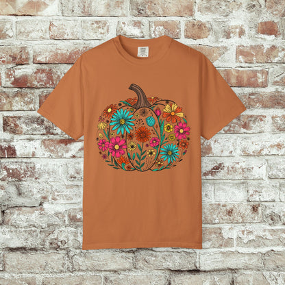 Yam t-shirt with a colorful pumpkin design on a brick wall background