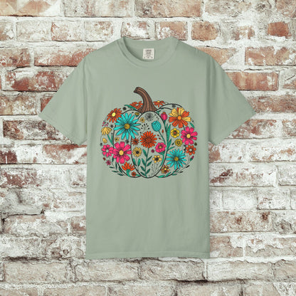 Bay sage green t-shirt with a colorful pumpkin and floral design on a brick wall background