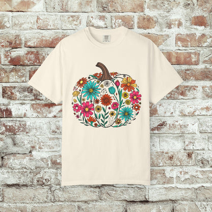 Ivory t-shirt with a colorful pumpkin and floral design on a brick wall background