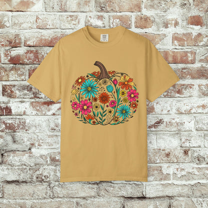 Mustard t-shirt with a floral pumpkin design on a brick wall background