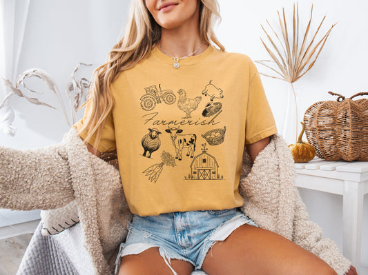Woman wearing a mustard yellow t-shirt with farm-themed graphics in a casual setting.