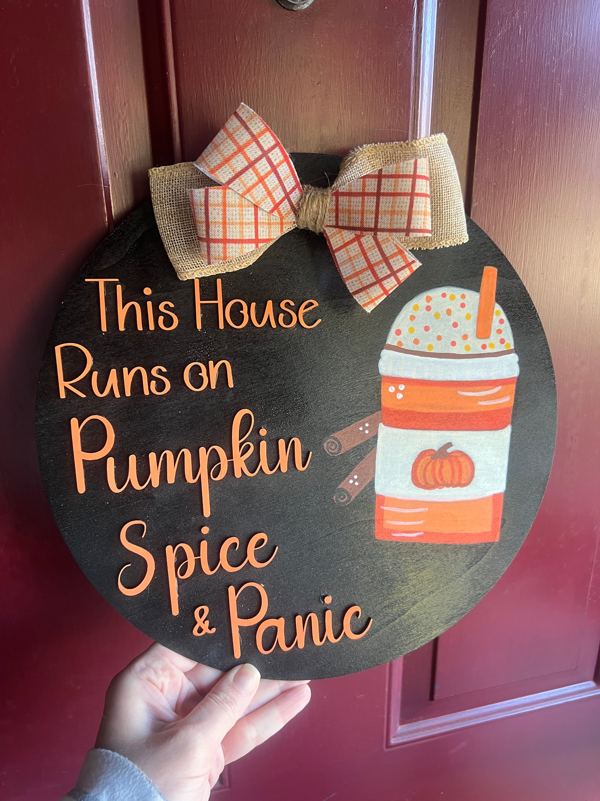 Decorative sign with pumpkin spice and panic text on a door