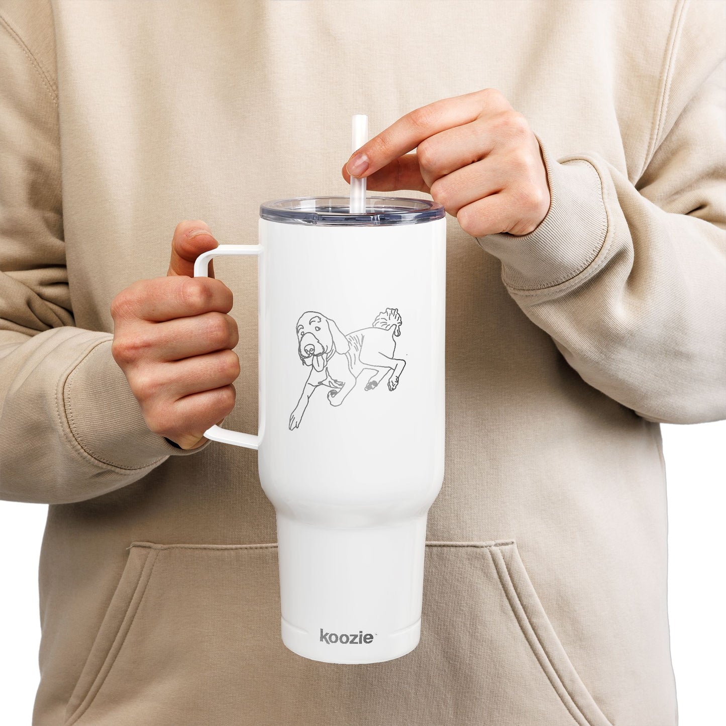 Person holding a white tumbler with a design and 'koozie' branding.